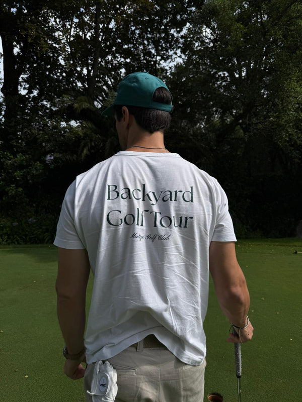 Person wearing a 'Backyard Golf Tour' shirt on a golf course